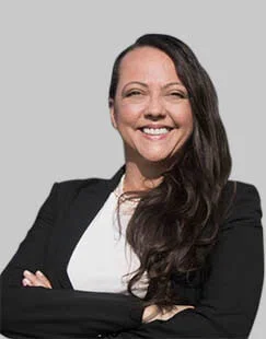 Lucy Petry, a tax advisor at Sullivan for IRS Matters, smiling confidently in professional attire during a office meeting